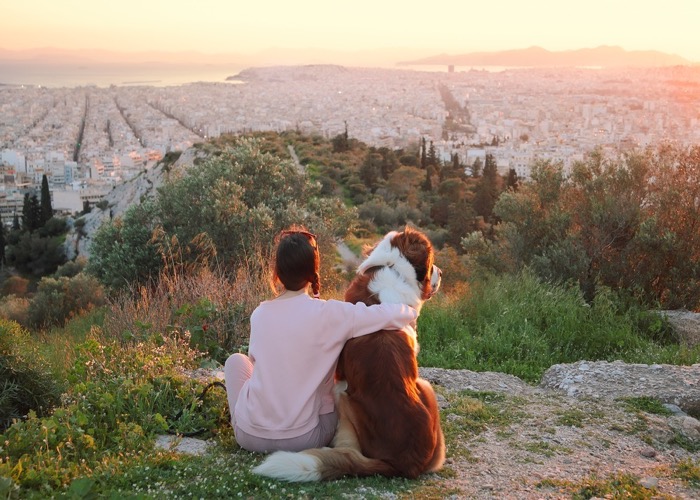 woman hugs her dog in Athens
