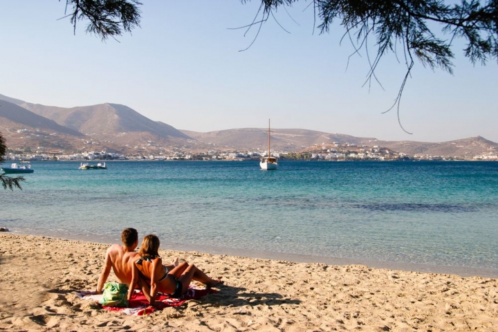 A couple sunbathing on a Paros beach - credits: Jan Hendrik/Shutterstock.com